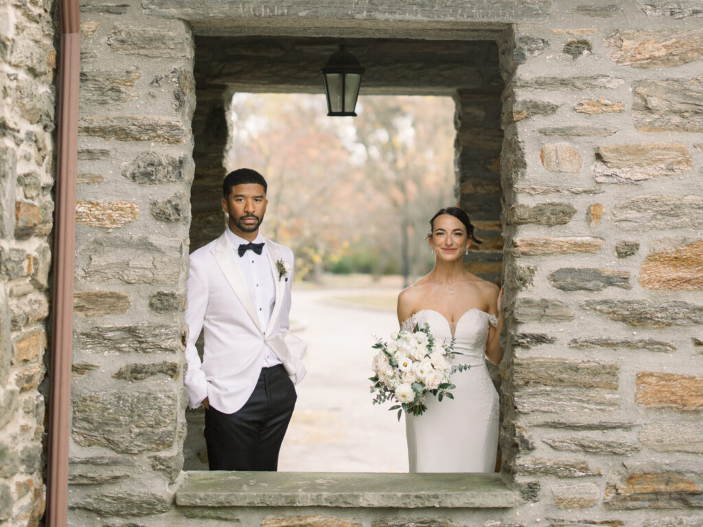 Bride and groom portraits surrounded by historic stonework at Flourtown Country Club