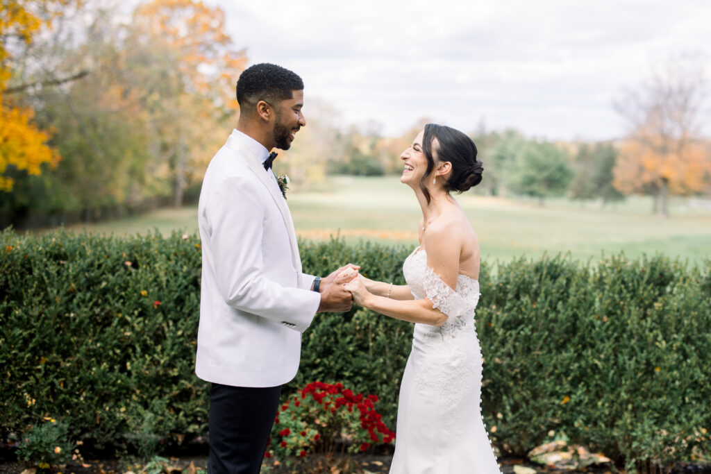Bride and groom sharing first look in the garden at Flourtown Country Club