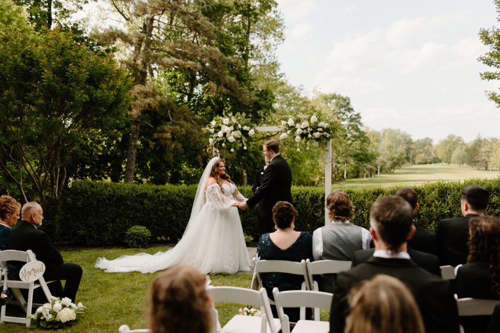 Bride and groom exchanging vows during ceremony at Flourtown Country Club